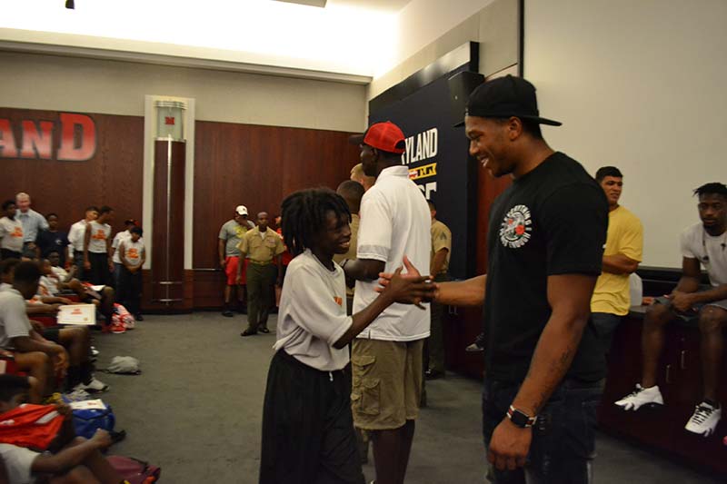 D.J. Moore shaking hand with a small boy