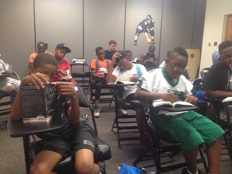 Students reading a book in the class room