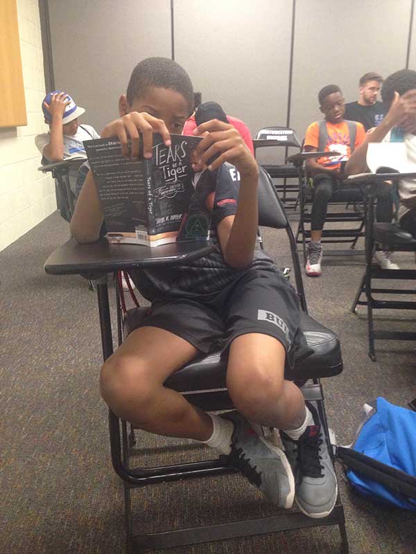 Close up view of boy reading a book