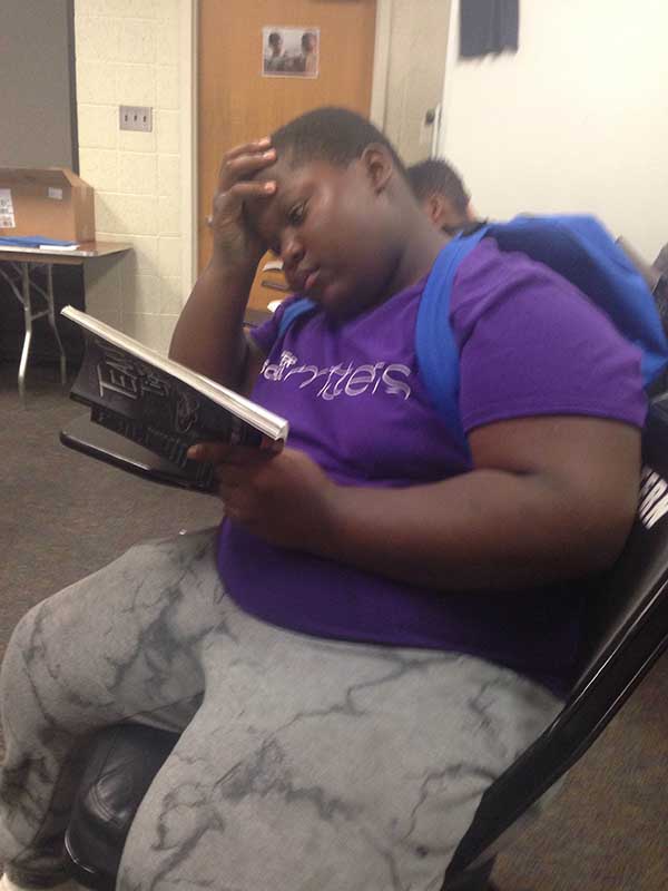 Close up view of boy reading a book