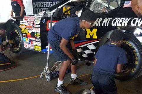 Students learning to replace the tire