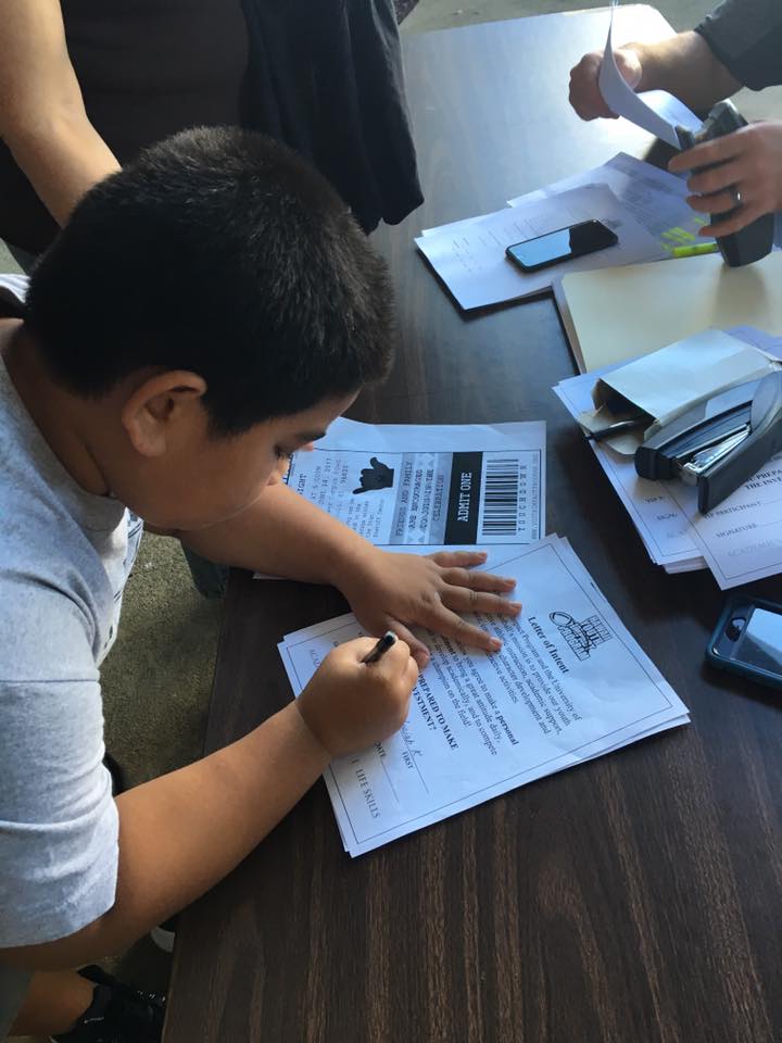Kid filling a form to participate in the program