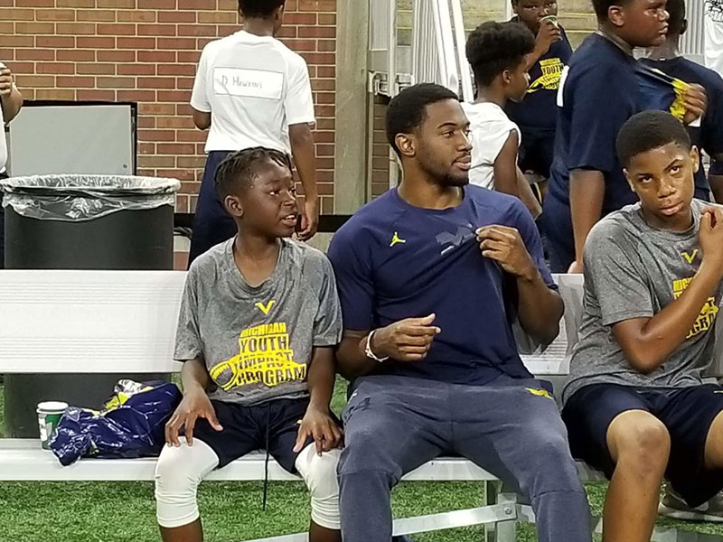 Father and sons sitting in the stadium bench