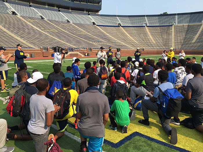 Children sitting on the ground in the stadium