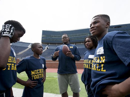 Team with the football discussing the game