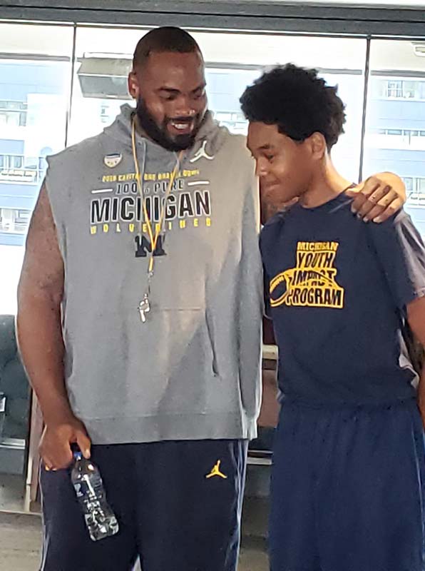 A boy talking to the trainer