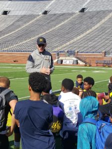 Coach talking with players in the stadium