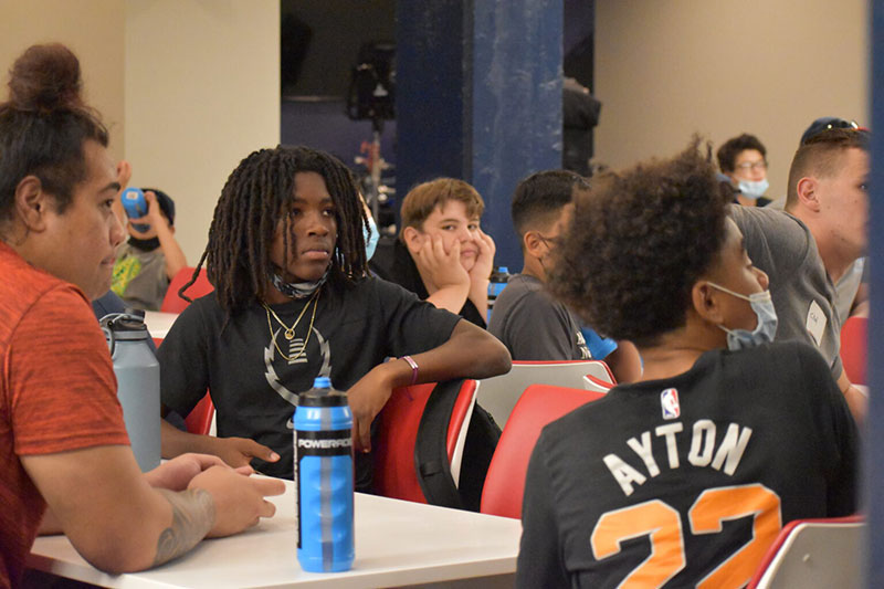 Football Team Members sitting in the circular conference