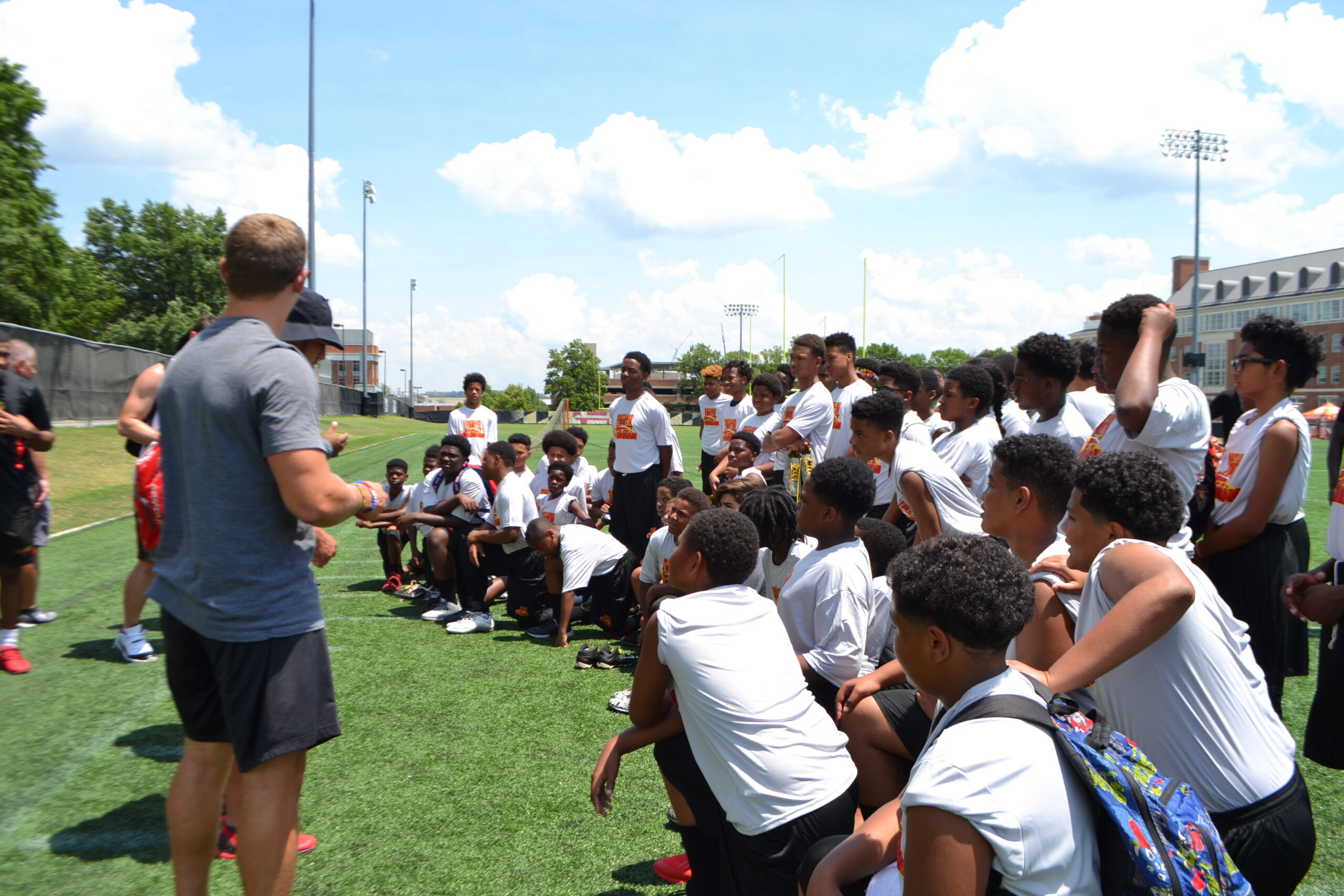 Students in the ground with the coach