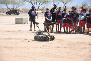 Coaches teaching students how to operate the equipments