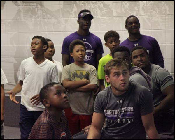 Students and Adults watching something attentively