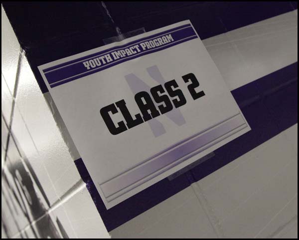 Sticker of class 2 placed on wall with blue and white paint