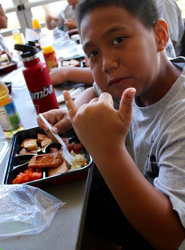 Boy eating food and posing for the photograph