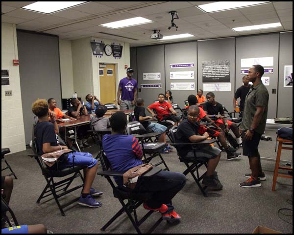 Students listening to coach in class