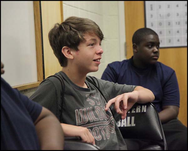 Student listening to coach in class