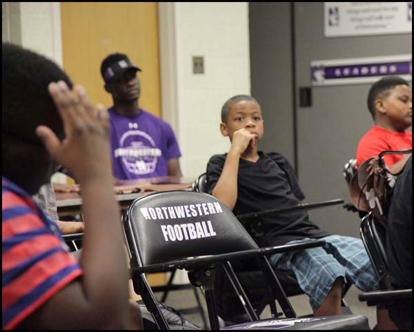 Student listening to coach in class