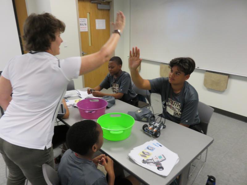 Coach and student giving high five