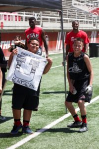 one boy handling the banner and other standing in the stadium