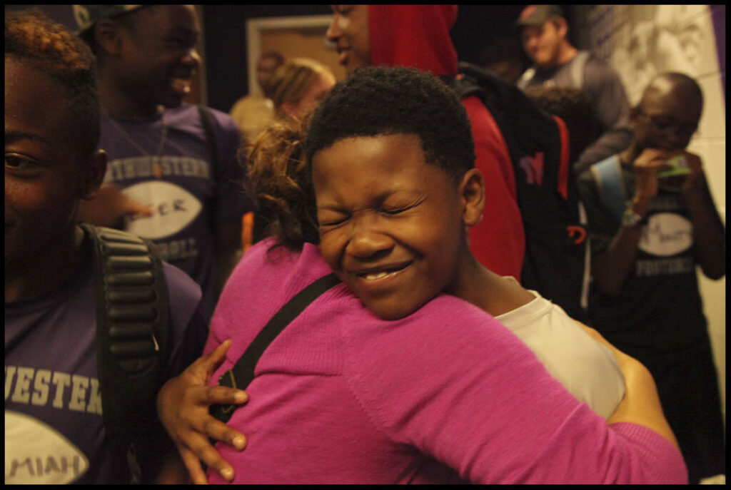 a boy hugging and smiling