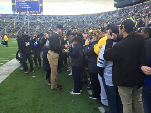 Coach talking to group of students