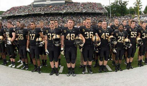 Football players standing in a row in the stadium