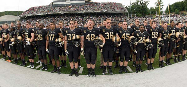 Football players standing in a row in the stadium