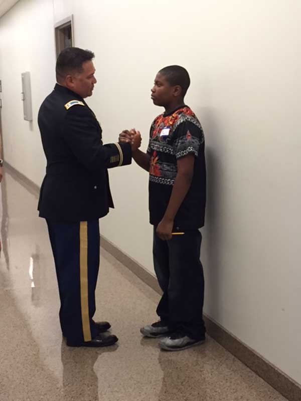 Officer shaking hands with student