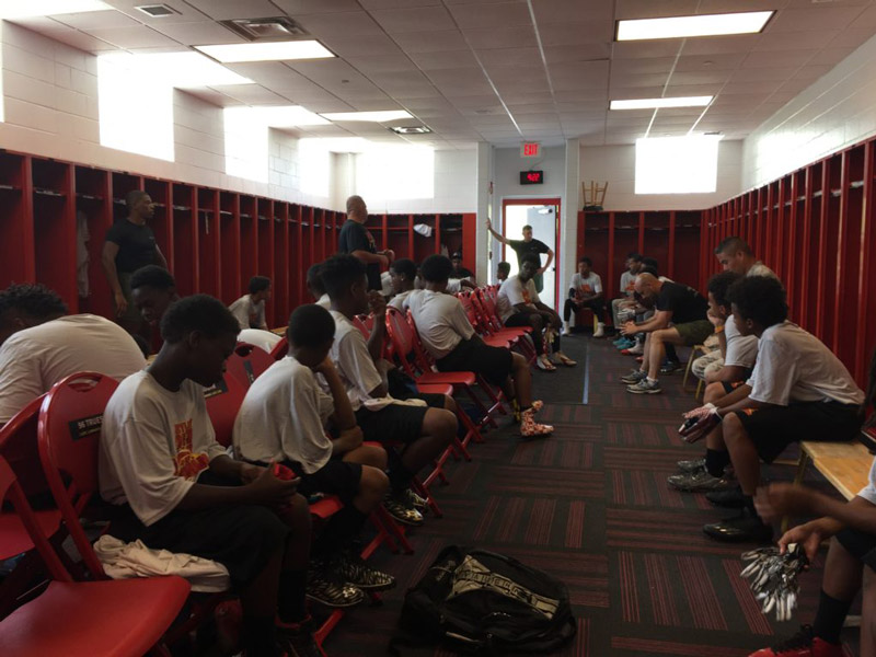 Coach talking to students in training room
