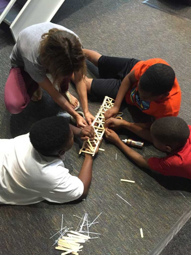 Students playing with sticks