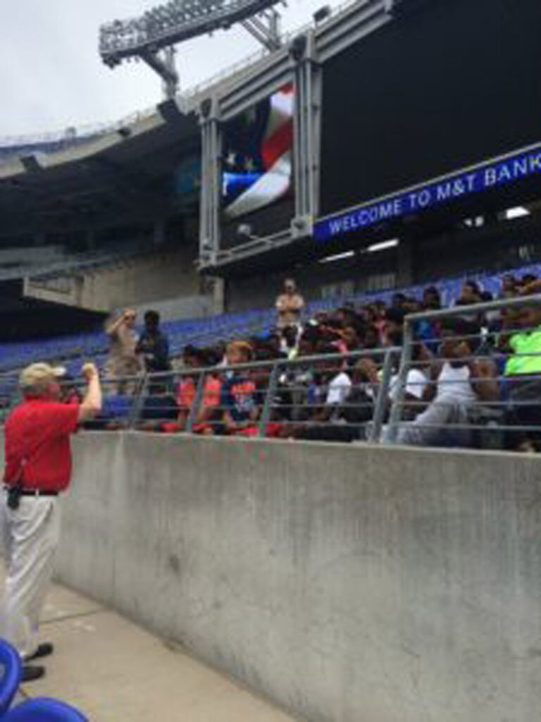 Coach talking to students in stadium