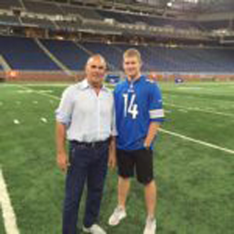 Coach posing with football star