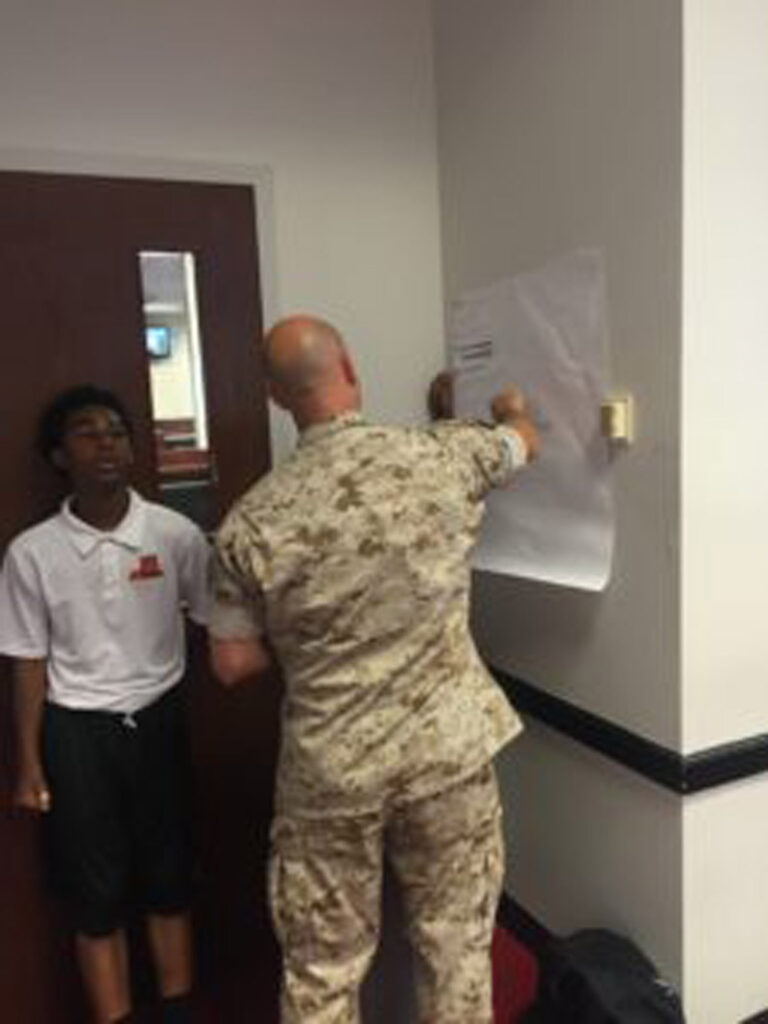 Army officer checking out information on a wall