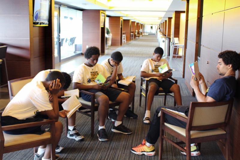 5 students studying in library