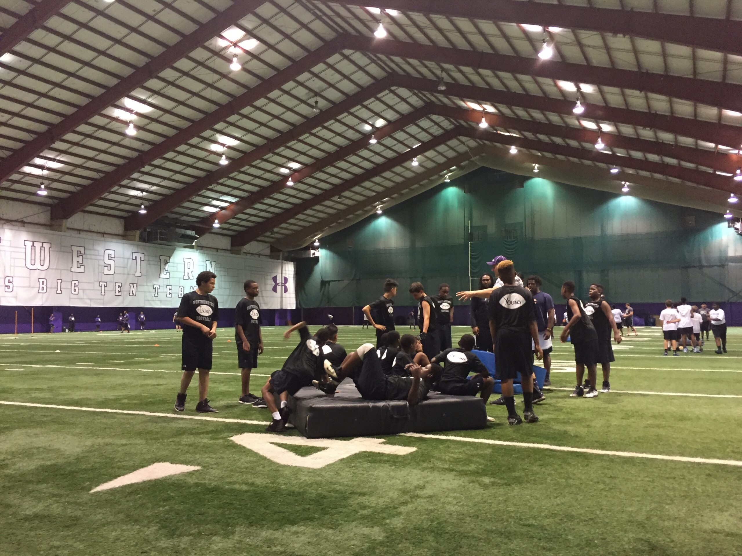 Students with the coach in the ground