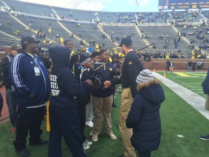 Coach talking to group of students