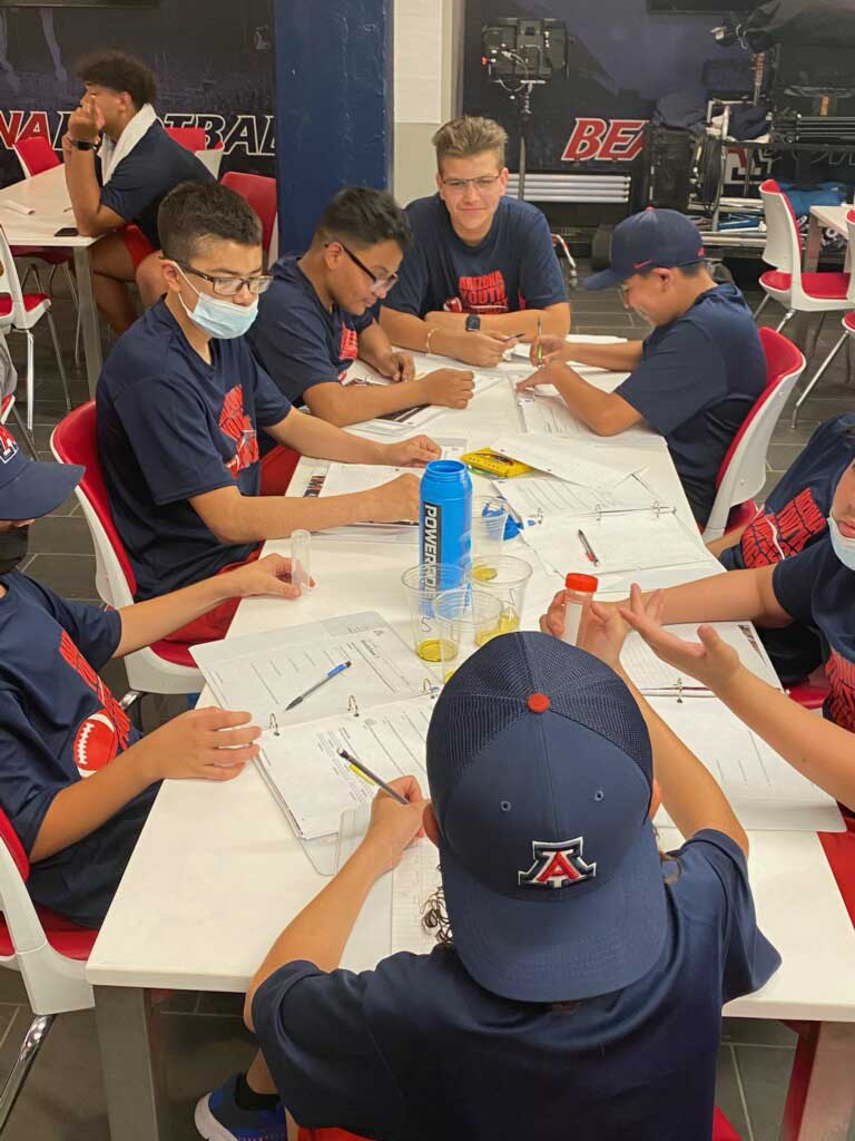 Football Team Members sitting in the circular conference