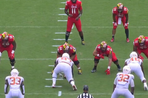 red color jersey team playing with opposite white color jersey team in the stadium