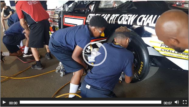 Students learning to replace the tire
