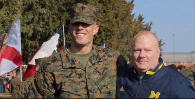 Soldier standing with one man