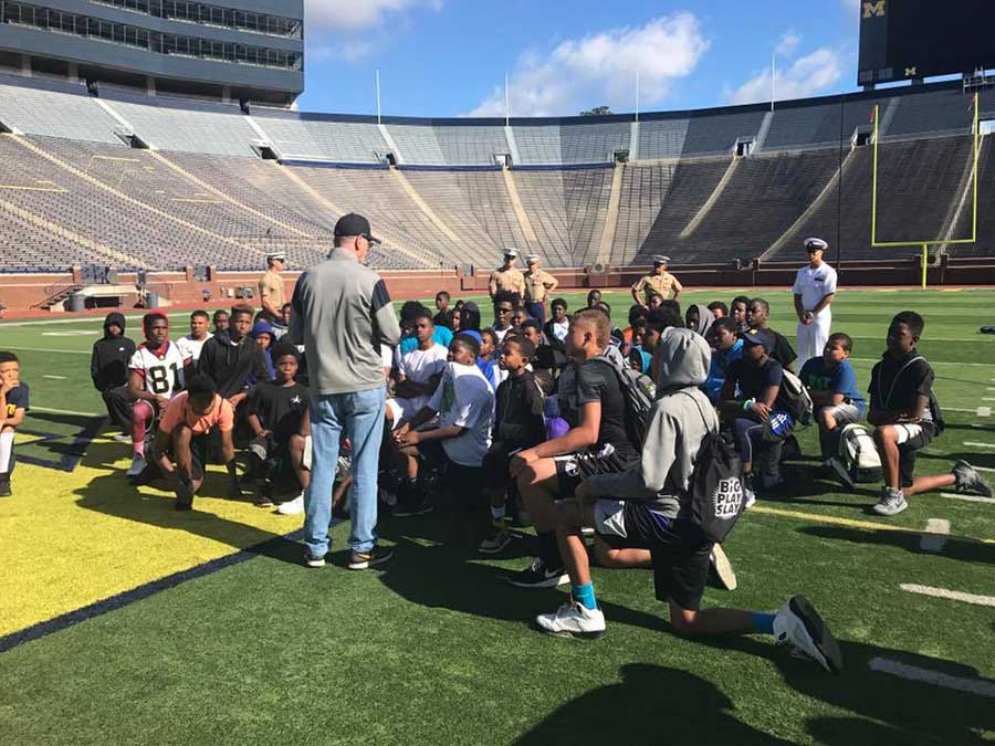 Instructor teaching boys in the stadium