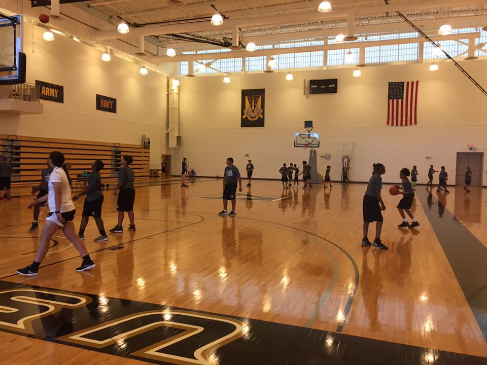 Players playing a basket ball in the court