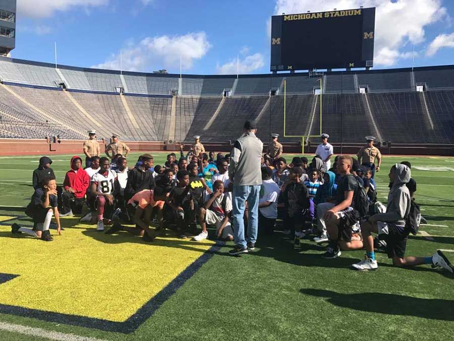 Instructor teaching boys in the stadium