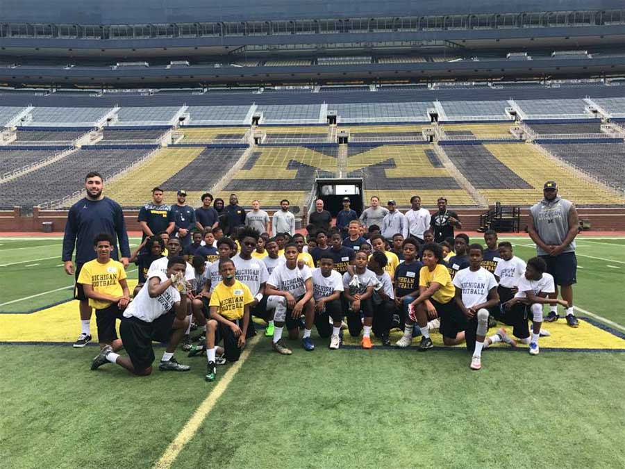 Group of boys with their instructors on the stadium ground