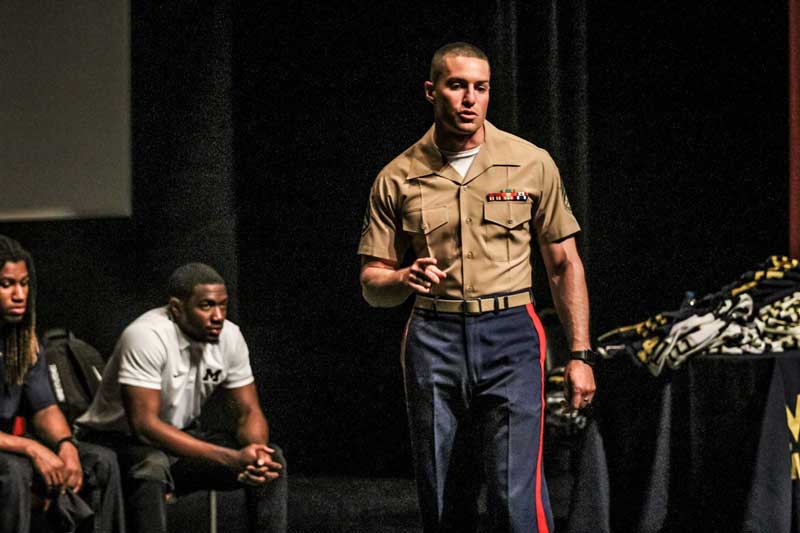 Man wearing a uniform standing on the stage