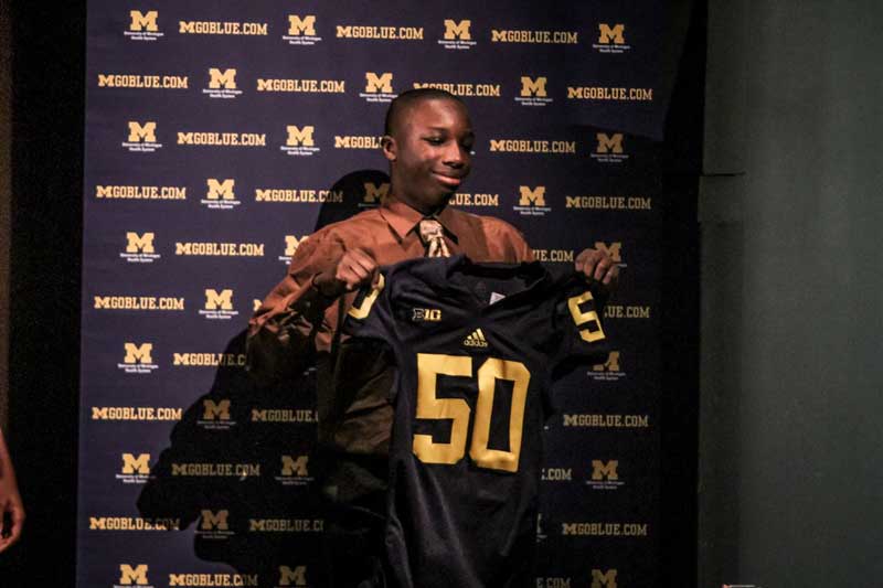 Man holding a sports jersey at the event