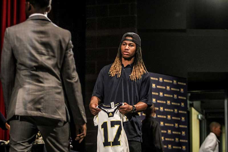 Boy holding a sports jersey