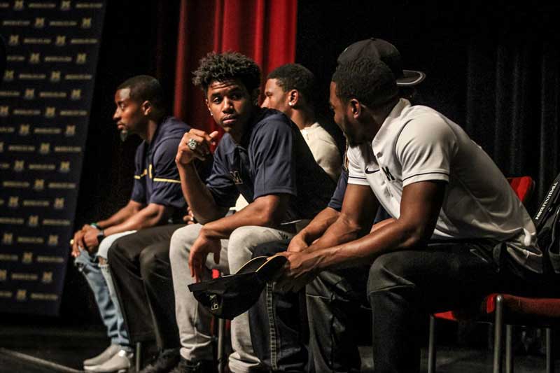 Men sitting on the stage