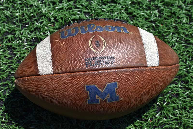 brown color football on the ground