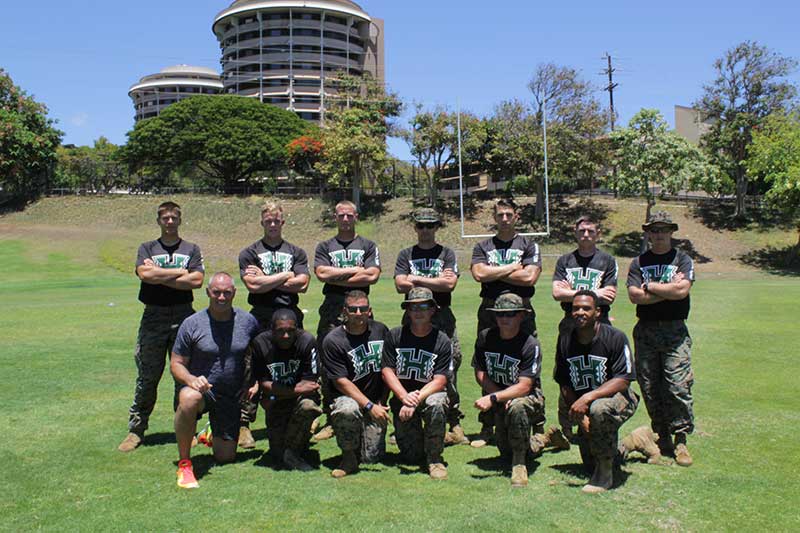 Men in a black jersey standing for the photograph