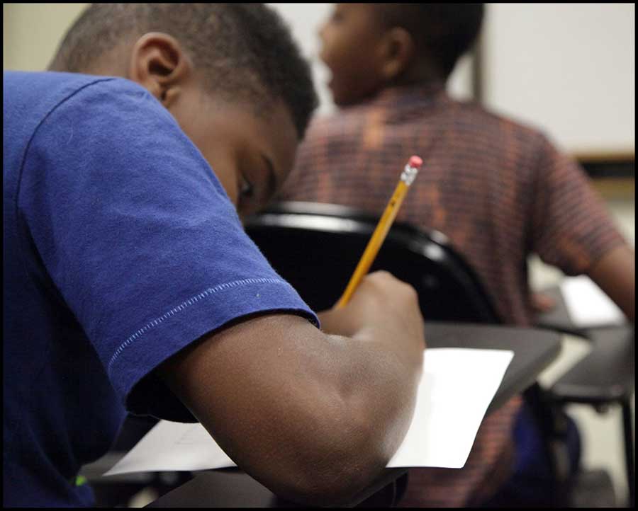 Student Writing in notebook